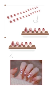 Detail of pink gradient press-on nails with white cherry blossom art and glitter