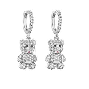 Macro shot of silver paved teddy bear earrings with pink nose and zircon detailing
