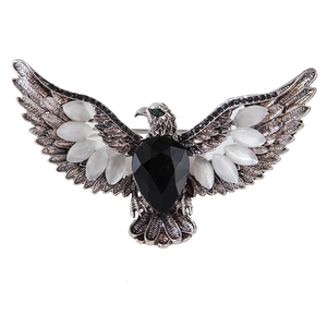 Retro eagle brooch with black teardrop gemstone and white opal wings in silver finish
