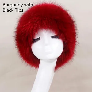Detail of wine red faux fur hat with black tips showing thick plush texture and volume