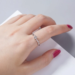 Macro detail of minimalist silver vine ring with oval white zircon and tiny side stones