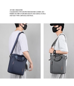Detail of durable nylon shoulder bags in navy and grey with reinforced handles and straps