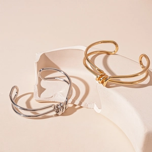 Minimalist double-layered geometric knotted open bangle in gold and silver finish