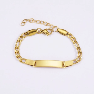 Macro detail of gold-plated Figaro chain kids ID bracelet with engravable metal plate
