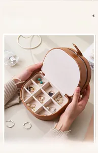 Detailed view of brown leather jewelry box with 9-compartment velvet lining storage
