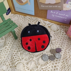 Close-up of mini ladybug plush coin purse with red and black wings and metal keychain