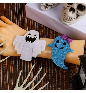 Detail of Halloween ghost wristbands with glitter finish on a decorative skeleton arm