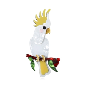 Handcrafted acrylic cockatoo bird brooch pin featuring a colorful parrot design on white