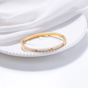 Elegant gold titanium steel bangle with white shell inlay and sparkling cubic zirconia