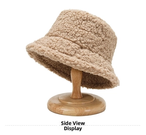 Detailed texture of a beige teddy fleece bucket hat on a wooden stand for winter warmth