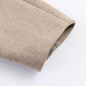 Detailed close-up of premium camel wool blend fabric cuff on a winter coat