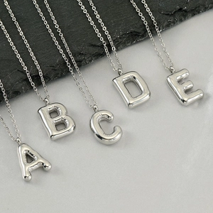 Chubby bubble initial necklace in silver stainless steel with playful 3D balloon letters