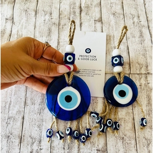 Blue glass Evil Eye hanging ornament with jute tassels for home and car protection décor