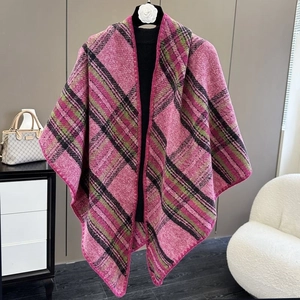 Detailed view of pink plaid knit poncho shawl with soft fabric texture and warm draping