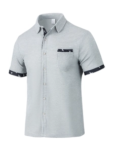 Close-up of light gray waffle knit shirt with bird print trim and size M tag detail