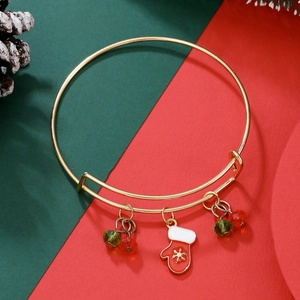 Detail of adjustable gold Christmas bracelet with red snowflake glove and festive beads