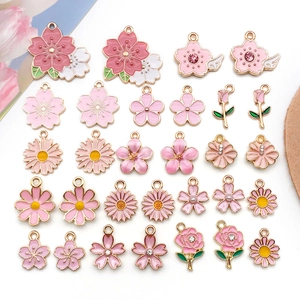 Detailed assortment of pink floral enamel pendants with gold accents and rhinestones