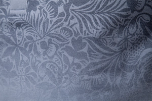 Close-up of polo shirt fabric showing gradient floral print and piqué cotton texture