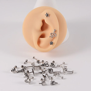 Detailed set of silver stainless steel studs featuring star, snake, and rose designs