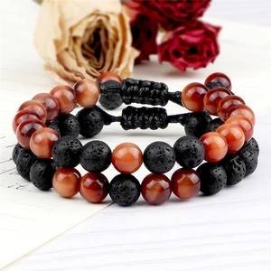 Detail view of 8mm green tiger eye and lava stone beaded bracelets with adjustable cord