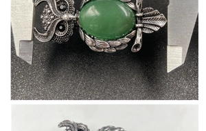 Detail showing natural green gemstone owl brooch width measurement using a caliper tool