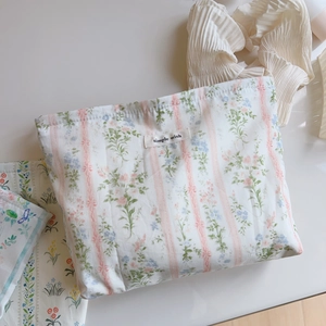Detail of floral and striped cotton makeup bag with a Simple Wish fabric label