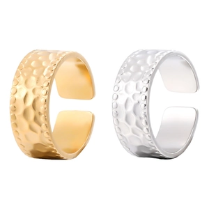 Detailed view of hammered gold and silver stainless steel open rings with adjustable bands