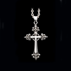 Detail of vintage textured 925 silver cross pendant on a dark background