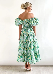 Detail of tiered skirt and smocked back on off-shoulder floral midi dress