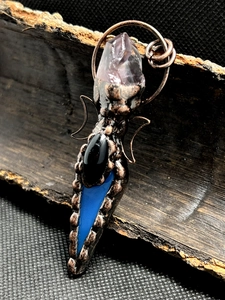 Detailed copper wire wrapped pendant with raw amethyst and teardrop blue gemstone