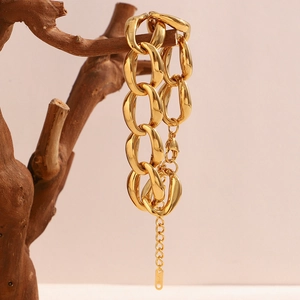 Minimalist 18K gold plated chunky chain bracelet hanging on a natural wood branch