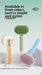 Three colorful self-cleaning pet grooming brushes with cat ear design on tiered stand