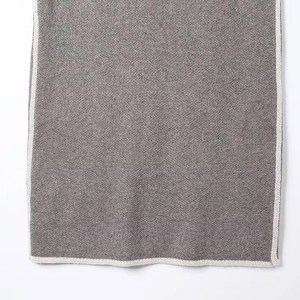 Detail showing high-quality gray knit fabric texture with white contrast trim detailing