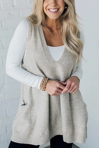 Detail of oatmeal V-neck knit vest showing high-quality fine texture and loose fit style