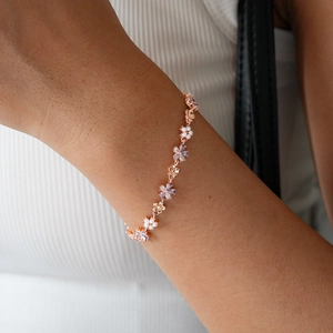 Detail of rose gold flower bracelet with lavender marquise stones and white pearls