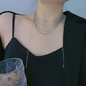 Silver multilayer layered chain necklace with long fringe tassels on female model