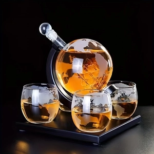 Detail view of globe whiskey decanter set with world map etching and wood base