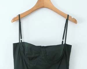 Detailed macro view of dark green camisole featuring shaped cups and slim shoulder straps
