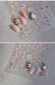 Detail showing 3D embossed Lunar New Year nail stickers with lion dance and floral patterns