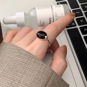 925 sterling silver ring with oval black onyx gemstone worn on hand in a modern setting