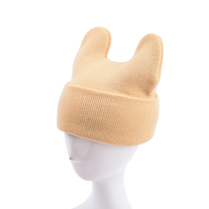 Detail of light yellow knit hat with cat ears and ribbed cuff on a model head