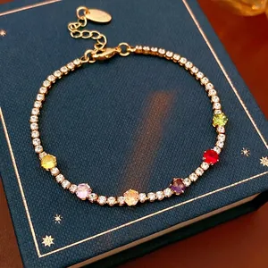 Vintage gold bracelet with rainbow zircons on a luxury star-patterned jewelry box