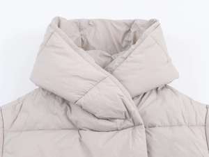 Detail view of the warm beige quilted collar and overlap windproof design on jacket