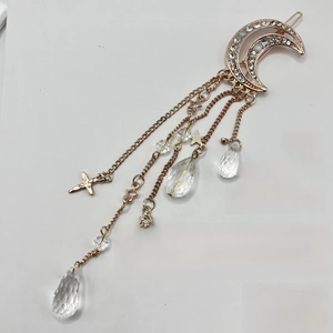 Sparkling moon hair clip with rhinestone tassels and star pendants in rose gold finish