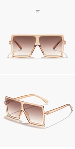 Detail view of square oversized kids sunglasses in champagne with brown gradient lenses