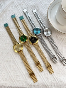 Close-up of GOLDRY quartz watches with colorful dials and metallic link bracelets