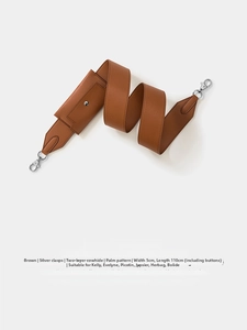 Macro detail of brown leather shoulder strap with palmar pattern and silver clasps
