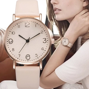 Minimalist women's rose gold watch with beige leather strap and model lifestyle view