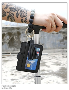 Wristlet silicone bead bracelet with black leather card holder and fringe tassel detail