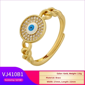 Macro view of brass Evil Eye ring featuring blue enamel and pave-set crystal details